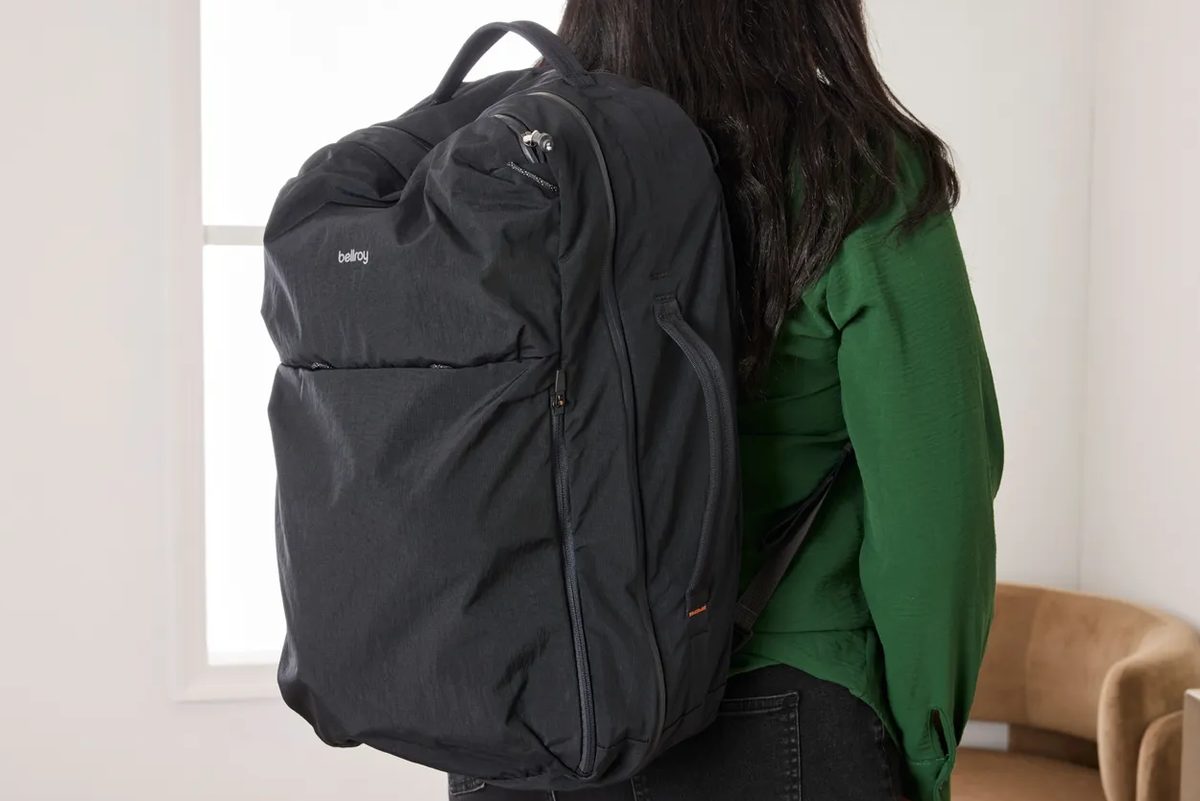 hand pulling Level8 carry-on zipper pull to show flex